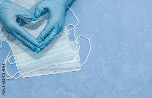 Protective medical white face mask on a blue background. View from above. Virus Prevention Space for text. Close up, gorizontal orientation