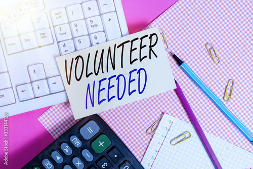 Handwriting text Volunteer Needed. Conceptual photo asking demonstrating to work for organization without being paid Note paper stick to computer keyboard near colored gift wrap sheet on table photo