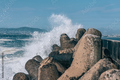 Fototapeta Naklejka Na Ścianę i Meble -  A concrete dolos with splashing wave 