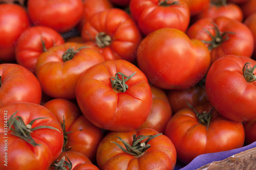 fresh tomatoes on branch in wicker baskets on counter fresh tomatoes on branch in wicker baskets on counter