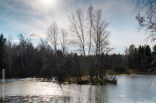 Lakes are freed from ice and flooded areas in early spring in the parks of St. Petersburg.