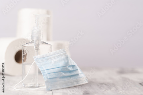 Wallpaper Mural Background for the disinfection of coronavirus. Sanitizer, protective medical mask, rolls of toilet paper. Compliance with disinfection, cleanliness, hand wet Torontodigital.ca