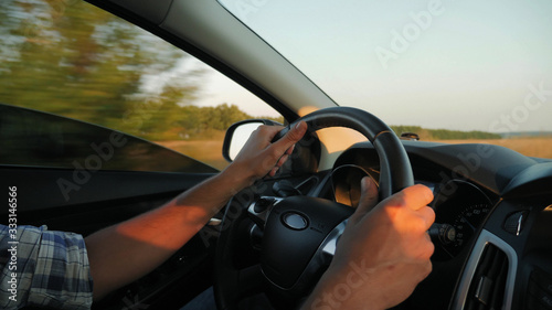 Closeup of man hands on steering wheel driving car, slow motion 4k video © DiedovStock