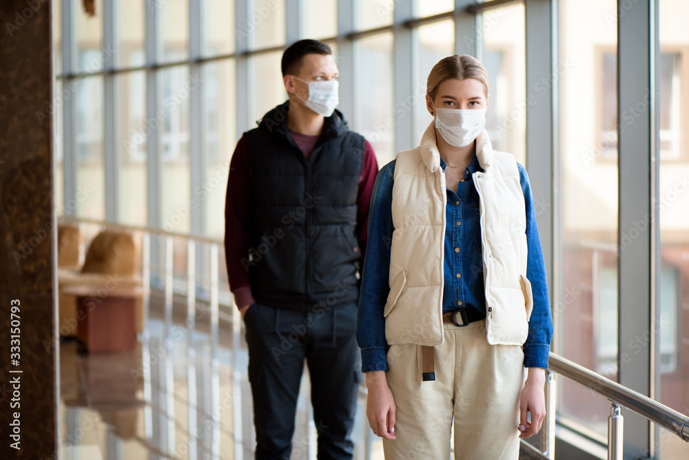 Concept of coronavirus quarantine. MERS-Cov, Novel coronavirus, man and woman with medical face mask Concept of coronavirus quarantine. MERS-Cov, Novel coronavirus, man and woman with medical face mask