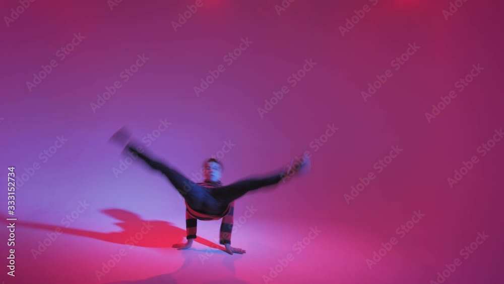 Young Man in a Jumper Dancing Contemporary Dance in Studio. Breakdancing. Dance School Poster. Copy Space. Battle competition announcement. Pink and Blue Background. Young Man in a Jumper Dancing Contemporary Dance in Studio. Breakdancing. Dance School Poster. Copy Space. Battle competition announcement. Pink and Blue Background.