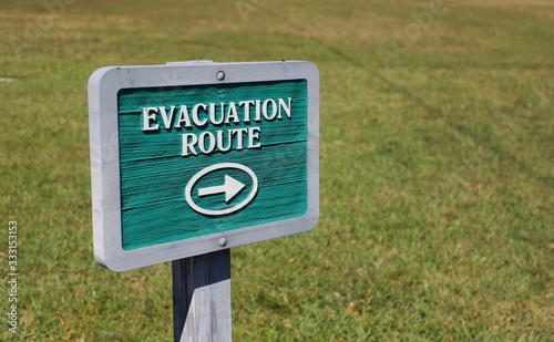 Wooden sign giving directions to evacuation route