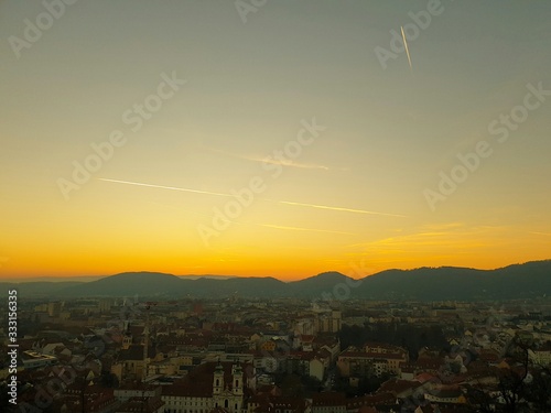 Sunset at the Schlossberg in Graz with a view of the west of Graz as well as mountains and trees