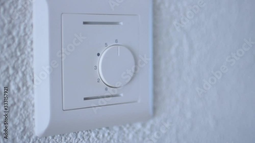 Man turns on the heating in the house