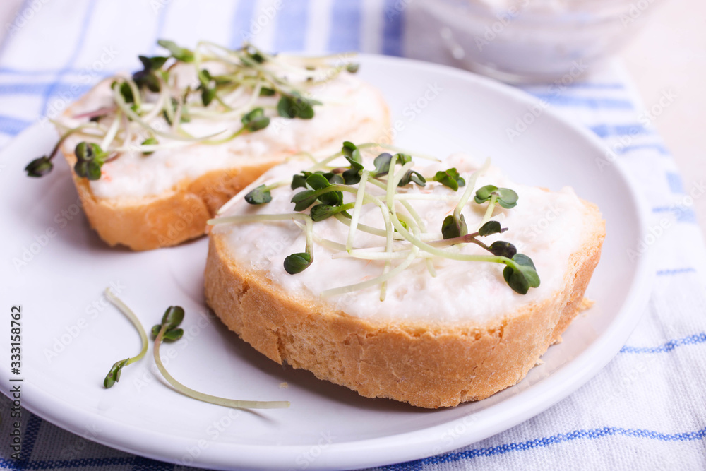 Toasts with cream and radish microgreen