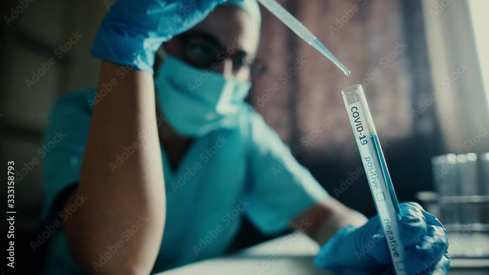 Conceptual video of a doctor taking samples from a test tube with a pipette, while testing for presence of coronavirus (COVID-19). Conceptual video of a doctor taking samples from a test tube with a pipette, while testing for presence of coronavirus (COVID-19).