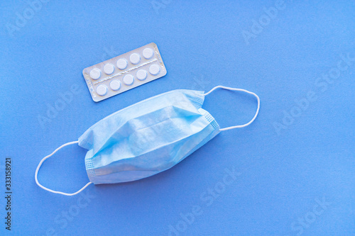 Aspirin in a blister medical dressing.  Vitamin C pills in a pack. White tablets in a blister on a blue background close-up with soft focus.