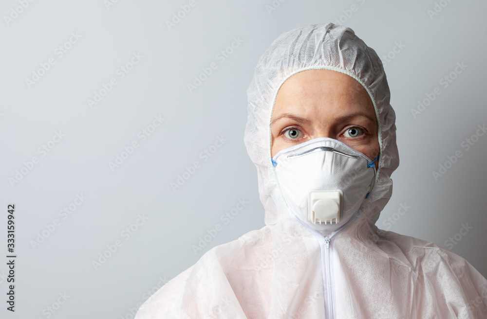 Woman in mask and protective suit, protection concept, close-up, copy space. Woman in mask and protective suit, protection concept, close-up, copy space.