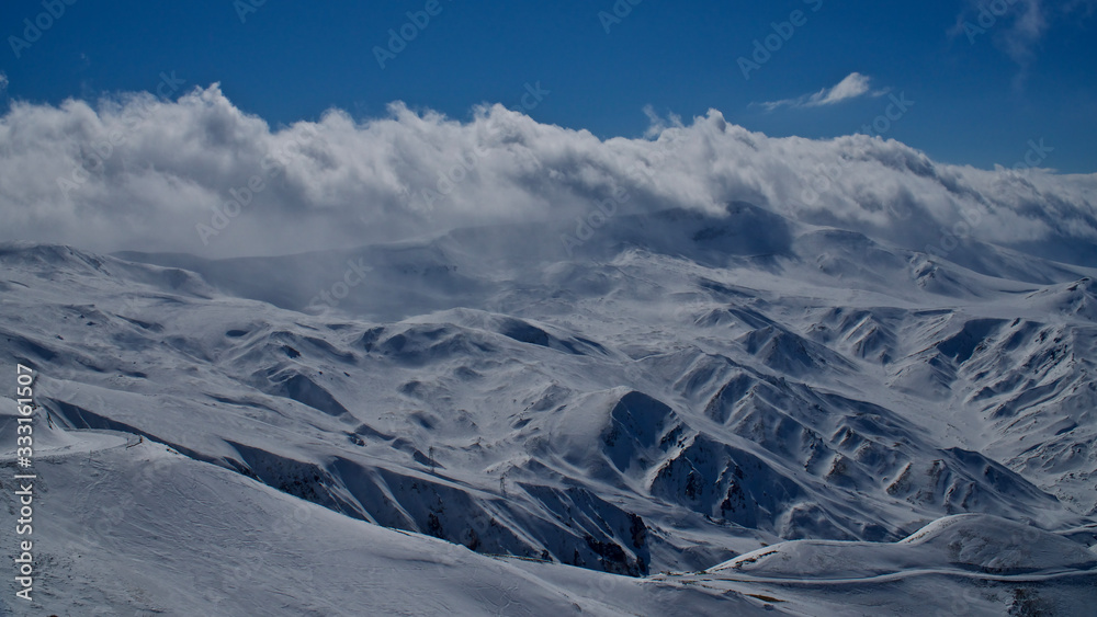 Erzurum Palandoken (Palandöken) mountains and cloudy sky. Palandoken ski resort. Snowy mountain ranges.