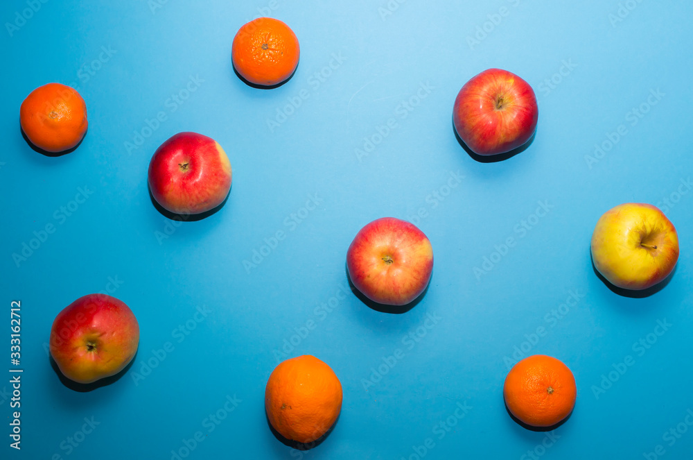Fruit background. Apples and mandarins are drawn in smooth lines on a blue background Fruit background. Apples and mandarins are drawn in smooth lines on a blue background