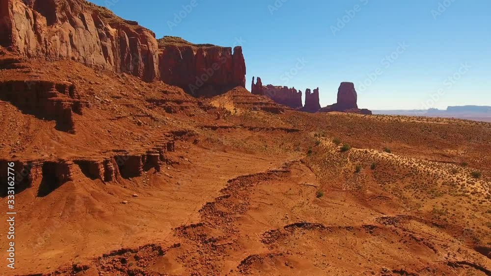 Monument Valley red rock desert Utah Arizona. Monument Valley Arizona Utah drone flying around Red rock climbing buttes towers desert southwest west hot dry sky Navajo nation reservation, plateau mesa
