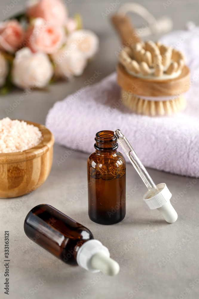 Brown dropper bottles on a blurry background. Beauty concept. Natural oils. Spa items. Brown dropper bottles on a blurry background. Beauty concept. Natural oils. Spa items.
