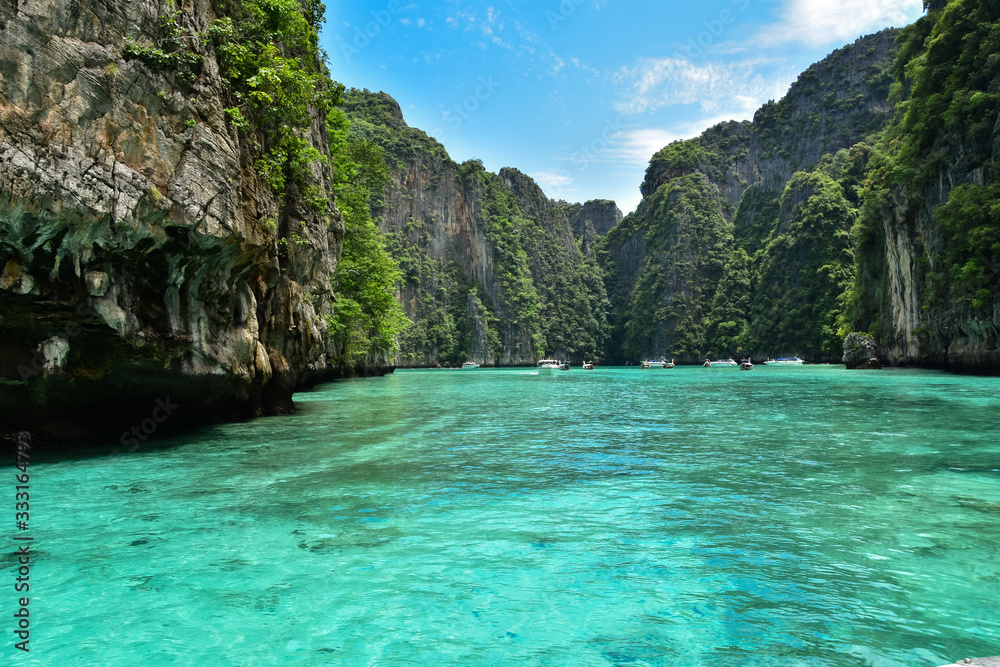 Breathtaking landscape in Koh Phi Phi with clear water and high limestone cliffs in great weather