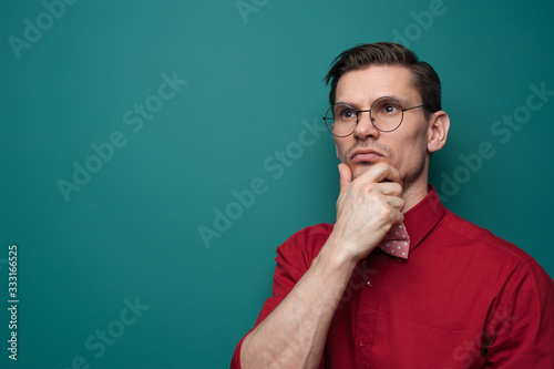 Close-up portrait of pensive young man in glasses