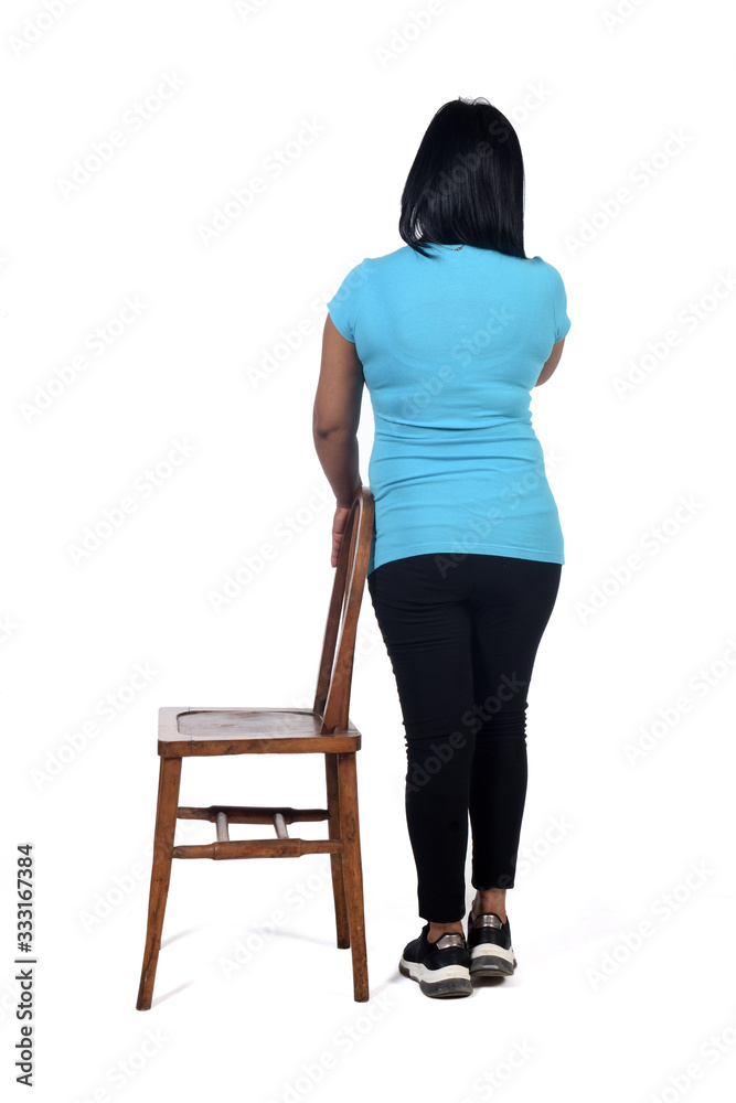 woman playing with a chair in white background, rear view woman playing with a chair in white background, rear view