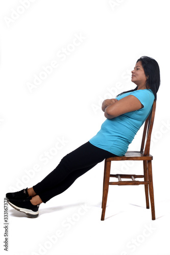portrait of a woman sitting and relaxing on a chair in white background,