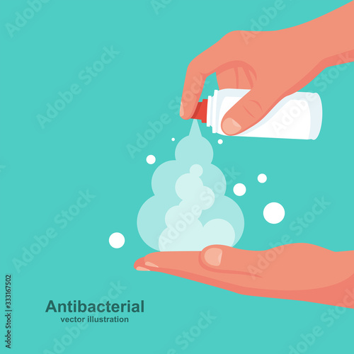 Man wipes hands with an antibacterial spray