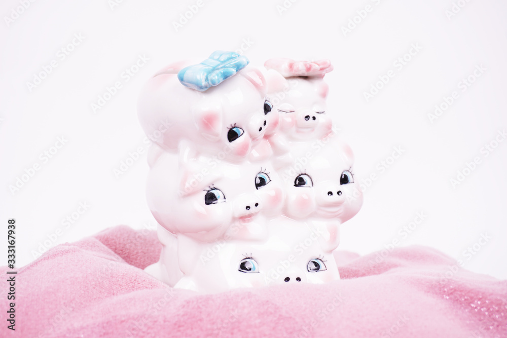 Ceramic piggy bank piggy for money. A symbol of the availability of money and savings. Photographed on a pink soft background. Ceramic piggy bank piggy for money. A symbol of the availability of money and savings. Photographed on a pink soft background.