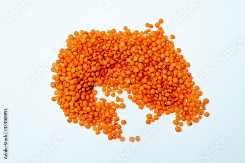 slide of red lentils on a white background. place for text. group. legumes. grocery