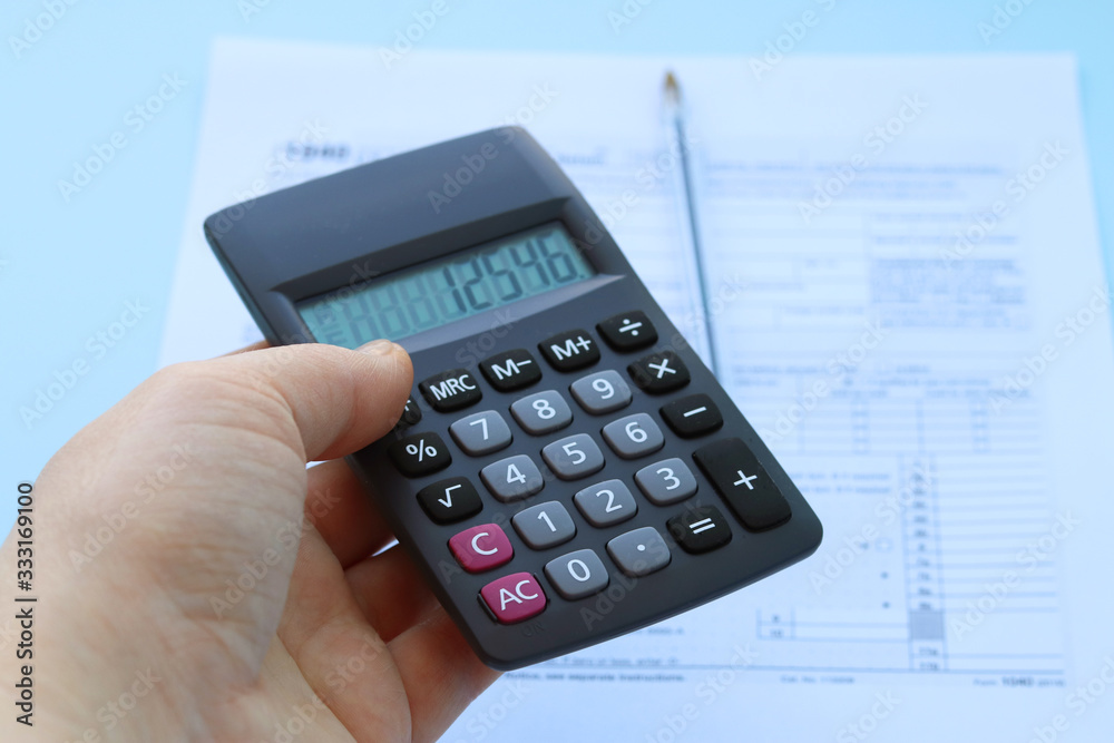Calculator with numbers 12546 in hand. Selective focus. Calculator with numbers 12546 in hand. Selective focus.