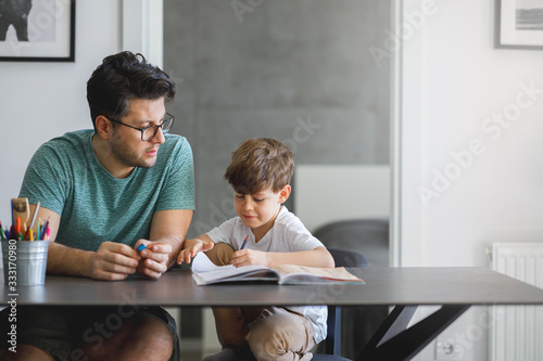 Father homeschooling his son