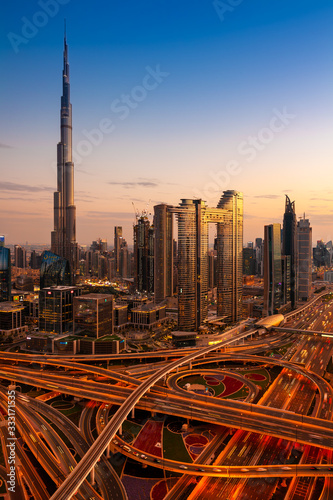The view of Dubai skyline with Burj Khalifa and Sheikh Zayed road at dusk, UAE