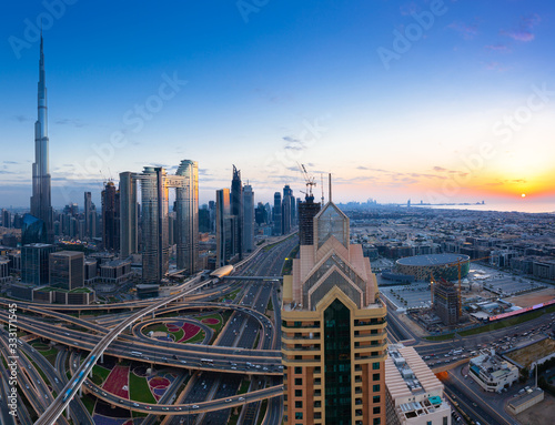 The view of Dubai skyline with Burj Khalifa  Sheikh Zayed road and sunset over the gulf  UAE