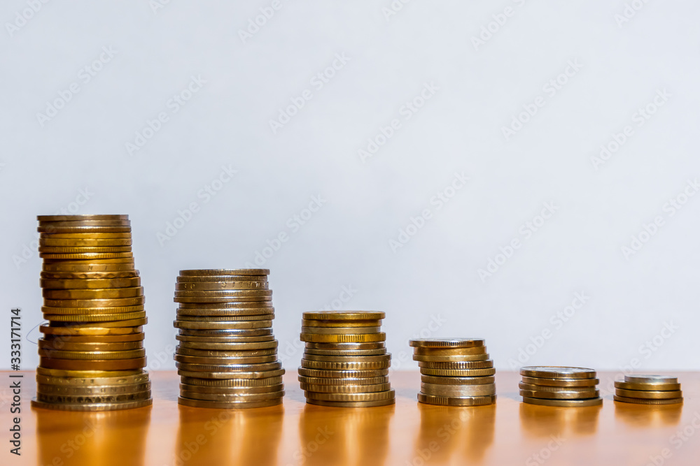 Six piles / stacks / towers of various coins ranged from the tallest one to the shortest one from left to right in the descending order Six piles / stacks / towers of various coins ranged from the tallest one to the shortest one from left to right in the descending order