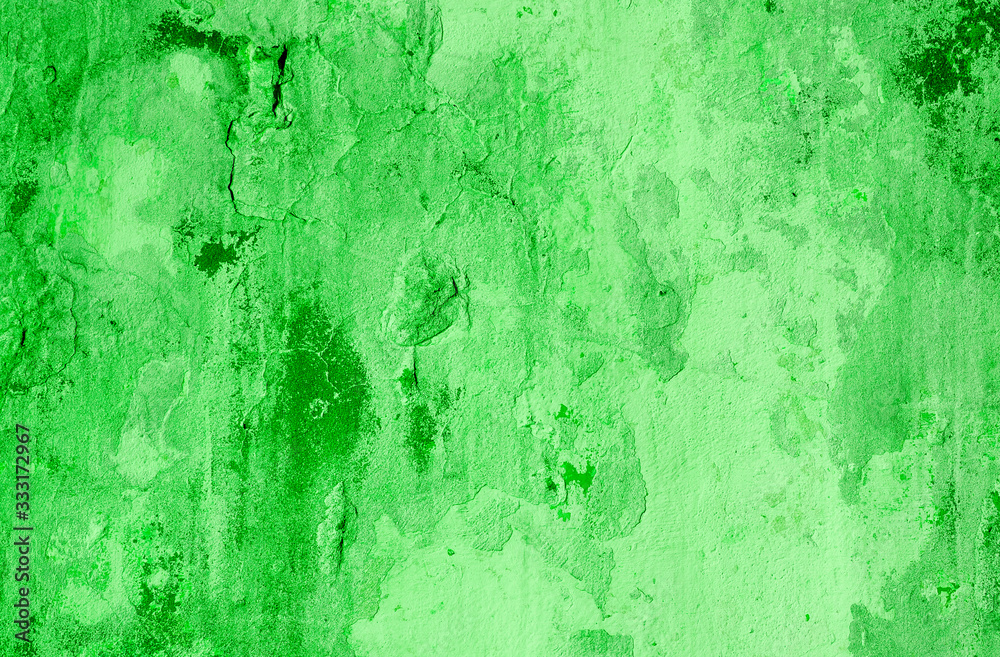 Green background. Wall with peeling plaster, tinted in green. Modern urban building concept. Bright neon backdrop. Selective focus Green background. Wall with peeling plaster, tinted in green. Modern urban building concept. Bright neon backdrop. Selective focus