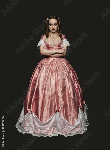 Beautiful woman in medieval dress on black background