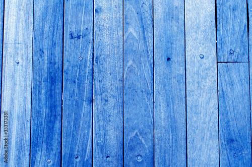 Bright blue wooden backdrop, boards. light blue tinted wood. Fragment of fence, floor or wall of building made of wooden boards, place for text. Copy space.