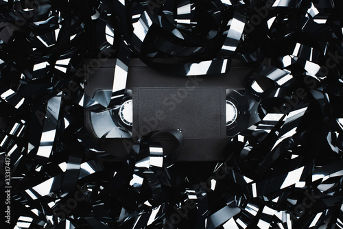 top view of black VHS cassette in film strip