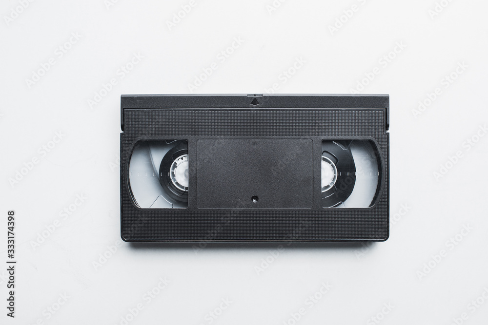 top view of old black VHS cassette on white background