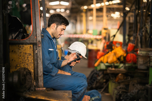 Professional technicians are resting and using mobile phones.