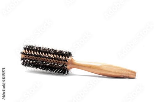 Round hairbrush with wooden handle isolated on white background.