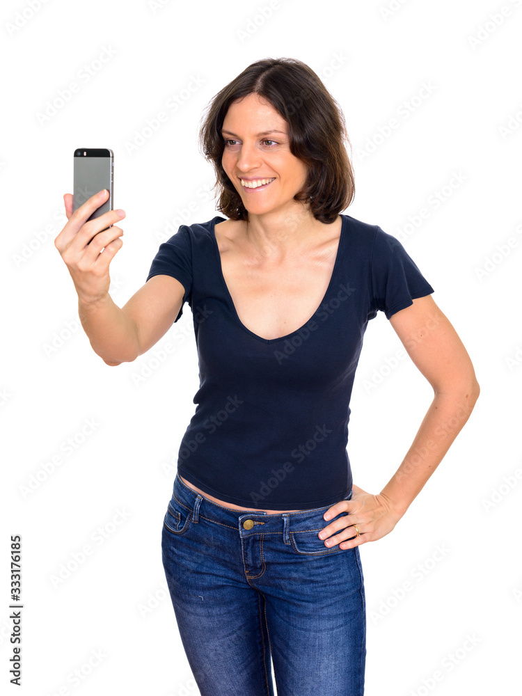 Studio shot of beautiful woman taking selfie isolated against white background Studio shot of beautiful woman taking selfie isolated against white background