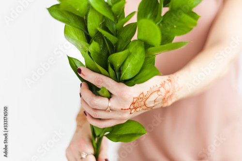 Girl of European appearance, henna drawing on hands, mahendi, girl in light clothes, yoga, spiritual development