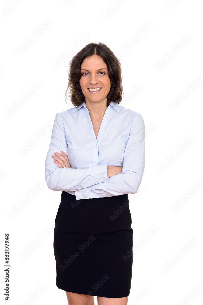 Studio shot of happy woman with arms crossed isolated against white background Studio shot of happy woman with arms crossed isolated against white background