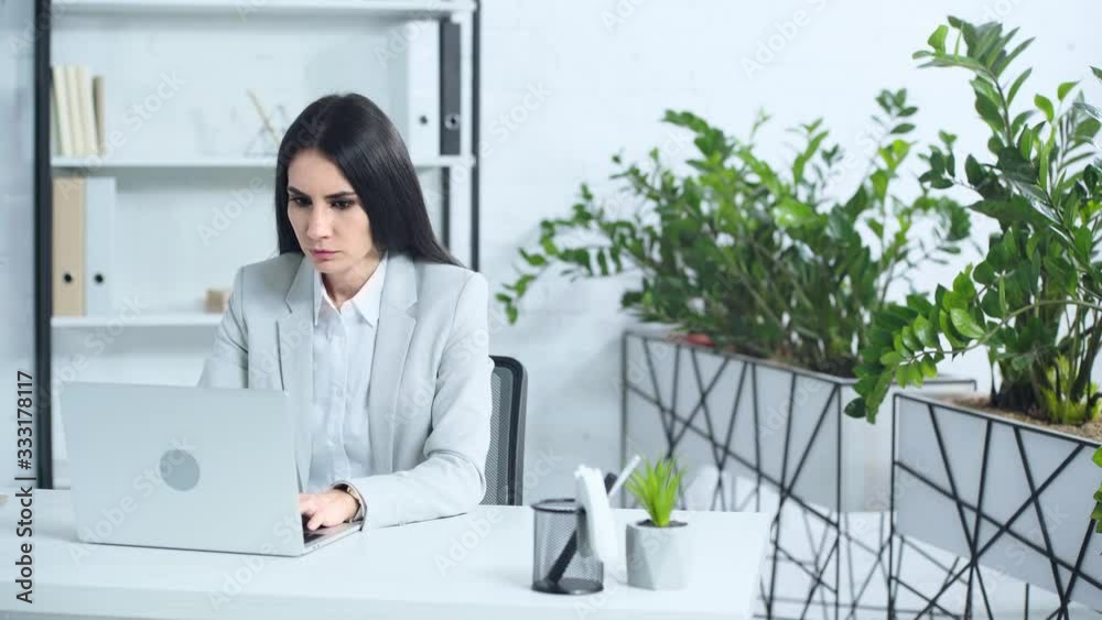 dissatisfied businesswoman using laptop in office dissatisfied businesswoman using laptop in office