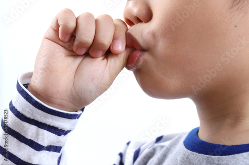 little boy sucking thumb isolated on white background