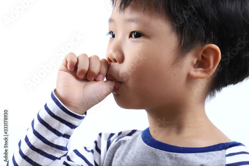 Fényképezés little boy sucking thumb isolated on white background