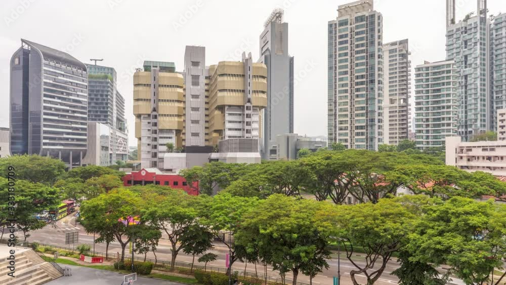 Aerial view of skyscrapers near Orchard road in Singapore timelapse. Trees and traffic on the street. Orchard road is one of best shopping district in Singapore. Aerial view of skyscrapers near Orchard road in Singapore timelapse. Trees and traffic on the street. Orchard road is one of best shopping district in Singapore.