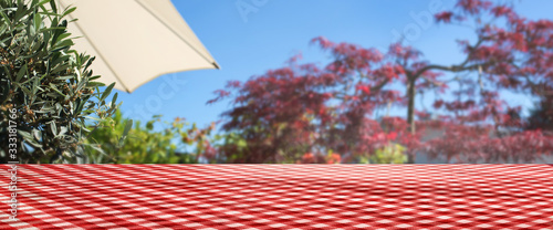 Checkered tablecloth on summer terrace photo