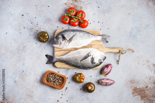 Fotografi Fish dishes cooking preparation with dorado in backing form in shape of fish wit