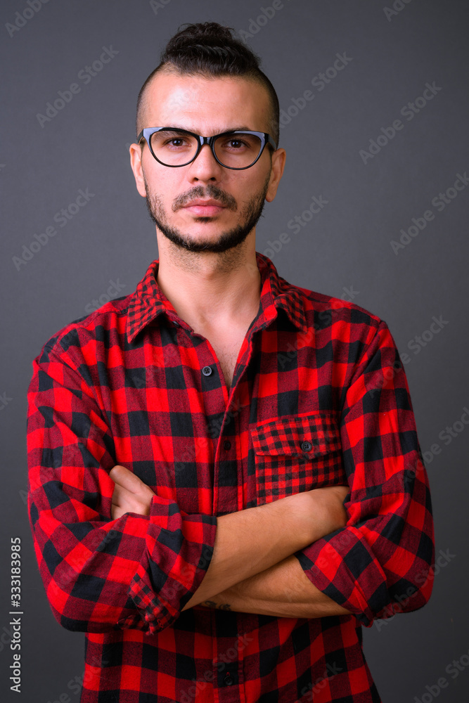 Fototapeta premium Handsome bearded Turkish hipster man with arms crossed