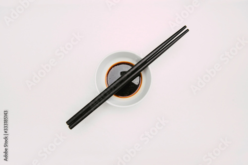 Stock photo of soy bowl with chopsticks on top and white background
